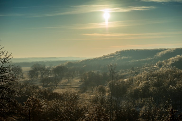 The morning sun shines on the sparkling ice covered Osage Hills.